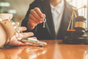 a judge giving keys to man in handcuffs and a gavel on the table representing the article about What is Early Termination of Probation